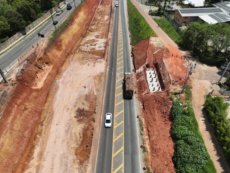 Fundação de nova estrutura em execução às margens da BR-277, no Paraná, com caminhão de transporte de madeira na pista